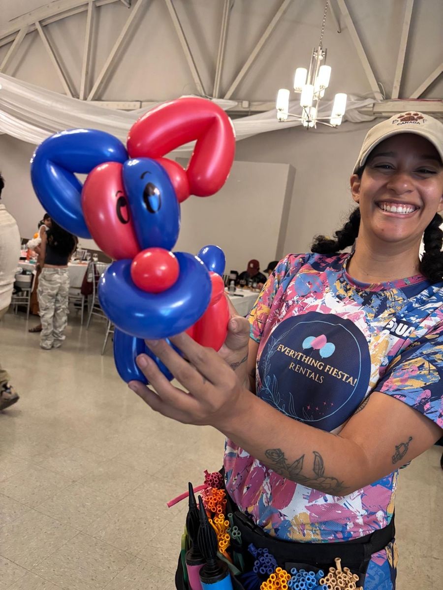 Everything Fiesta Rentals team member with balloons at an event